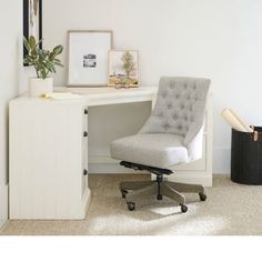 an office chair sitting in front of a white desk