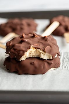 chocolate covered ice cream pops are on a baking sheet and ready to be dipped with marshmallows