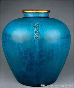 a large blue vase sitting on top of a table