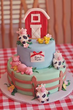 a three tiered cake decorated with farm animals