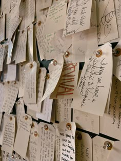 many handwritten notes are pinned to the wall