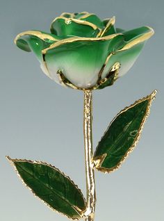 a glass rose with green leaves on it