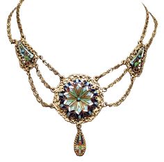 an elaborate necklace is shown on a white background