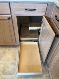 an open cabinet drawer in a kitchen