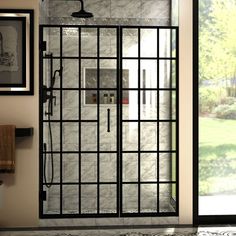 a bathroom with a glass shower door and tiled floor