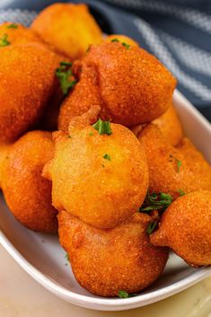 a white bowl filled with fried food on top of a table