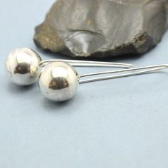 "Sterling silver ball earrings, dangle ball earrings, Long contemporary earrings, simple jewelry, modernist gift for her High polished ball simple earrings in sterling silver Lovely for everyday and casual dressing. The shiny balls are 14 mm and the total length is 45 mm -1 1/2\" inches All our items comes beautiful wrapped. if you need additional information please don't hesitate to contact me You can see more shop listings here: http://www.etsy.com/shop/nikiforosnelly" Minimalist Sphere Earrings For Everyday, Sterling Silver Sphere Earrings, Pierced Sphere Sterling Silver Earrings, Pierced Sterling Silver Sphere Earrings, Sterling Silver Sphere Earrings For Gift, Minimalist Sterling Silver Sphere Earrings, Casual Dressing, Silver Pearl Earrings, Contemporary Earrings