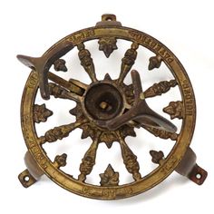 an antique brass compass with four pointed stars on it