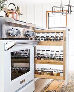 a kitchen with an oven and spice rack