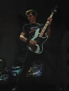 a man playing an electric guitar on stage