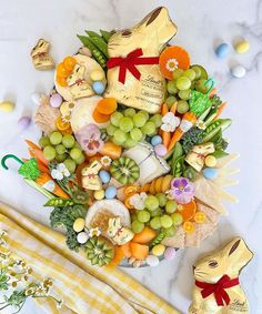 a table topped with lots of different types of fruit and veggies on top of each other