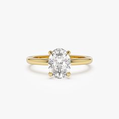 a yellow gold engagement ring with an oval cut diamond