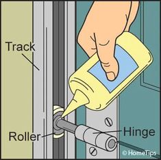 a hand holding a yellow spray bottle and pointing at the handle on a sliding door