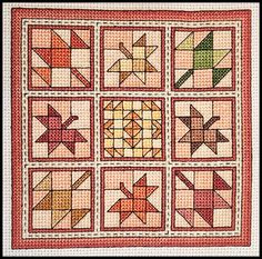 a quilted wall hanging with nine squares and arrows on the sides, all in different colors