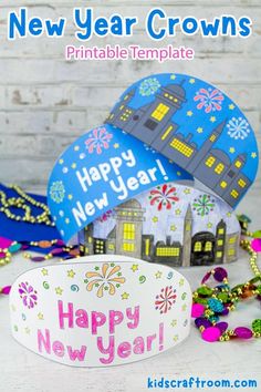 two new year crowns sitting next to each other on a table with beads and confetti