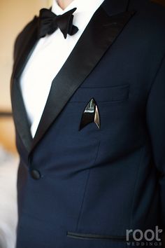 a man in a tuxedo with a star trek pin on his lapel