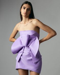 This lavender dress has an oversized, dramatic fan detail on the upper front, creating a unique and eye-catching look. This elegant dress, in light violet color, has a slightly rounded lower part, adding a touch of sophistication to its silhouette. Make a statement with this one-of-a-kind dress. * Versatile Elegance: Perfect for wedding guest outfits, bridesmaid duties, birthday parties, cocktail parties, or as a thoughtful gift for her.  *Sustainable Fashion: Crafted from deadstock recycled polyester, this dress is not only beautiful but also environmentally conscious. DETAILS - Front dramatic fan detail - Corset dress - Back hidden zipper closure - Handmade COMPOSITION - 100% recycled polyester CARE INSTRUCTIONS - Dry Clean Only - Iron at medium temperature - Do not tumble dry NOTE - Ple Lavender Mini Dress, Violet Dress, Wedding Guest Outfits, Bridesmaid Duties, Dress Lavender, Lavender Dress, Light Violet, Fashion Week Outfit, Thoughtful Gifts For Her