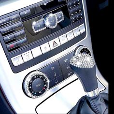 the interior of a car with an automatic gear lever and diamond - encrusted knobs