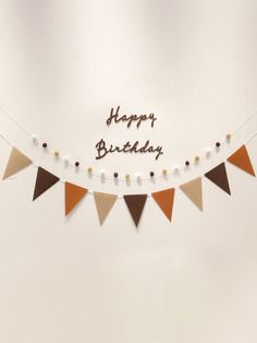 a happy birthday banner with brown and white buntings on the bottom of it