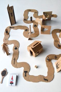 an assortment of cardboard cutouts and magnets on a white surface with various objects