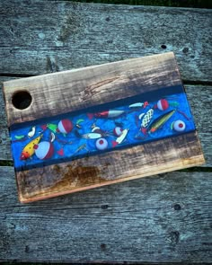 a wooden tray with fish painted on it