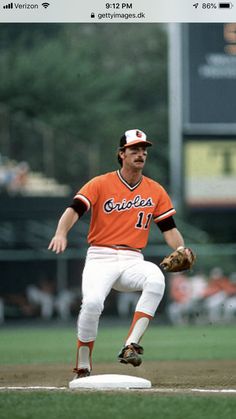 a baseball player in an orange and white uniform