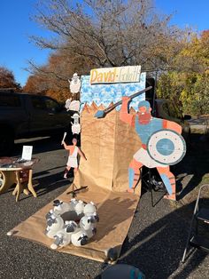 two children are standing in front of a paper mache