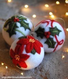 three decorated christmas balls sitting on top of a table