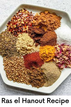 a white plate topped with lots of different types of spices and seasonings on top of each other