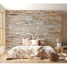 a bedroom with a stone wall and wooden flooring in the room, along with a bed that has pillows on it