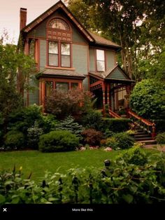 the house is surrounded by trees and bushes