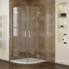 a corner shower stall in a tiled bathroom