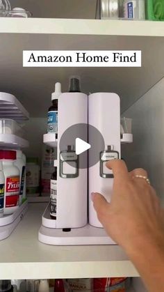 a person is pointing to the bottom shelf of a kitchen cabinet with shelves full of medicine and other items