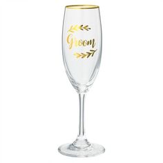 a wine glass with the word groom written in gold foil on it's side