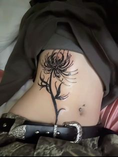 a woman's stomach with a tattoo on it