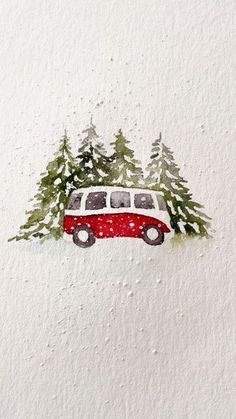 a red and white van driving down a snow covered road with trees on the roof