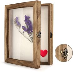 a shadow box with flowers and a heart in it