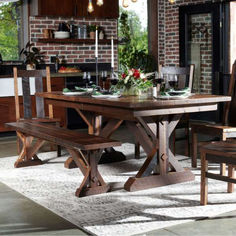 a dining room table with two chairs and a bench in front of an open kitchen