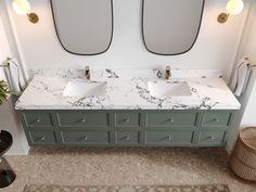 two sinks and mirrors in a bathroom with marble counter tops, gold handles, and brass fixtures