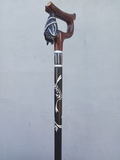 a black and white cane with a wooden handle