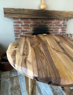 a wooden table sitting in front of a fire place