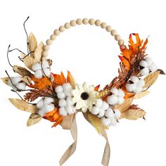 a wreath made out of cotton, leaves and other things is displayed on a white background