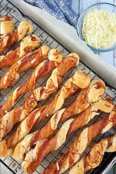 bacon wrapped pretzels sitting on a cooling rack