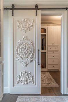 an open white door leading to a walk in closet