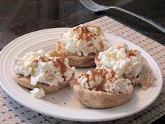 a white plate topped with mini pies covered in whipped cream on top of a table