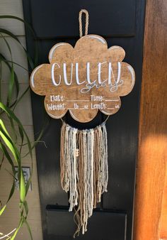 a wooden sign hanging from the side of a door that says gulley and it's written in cursive writing