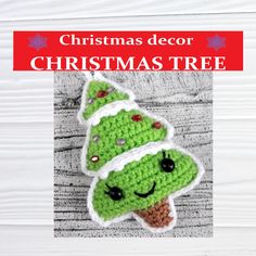 a crocheted christmas tree ornament hanging on a white wooden background with text overlay