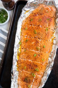 a piece of fish is sitting on tin foil and ready to be cooked in the oven