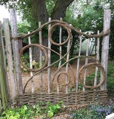 a garden gate made out of wood and wire