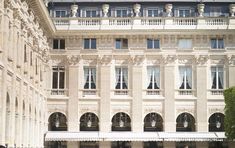 the building has many windows and balconies on it's sides, along with an awning for shade